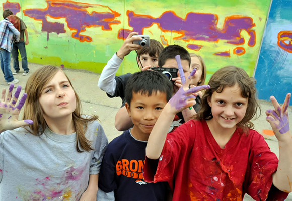 Students at Brown celebrate the progress they have made on this mural painting day.