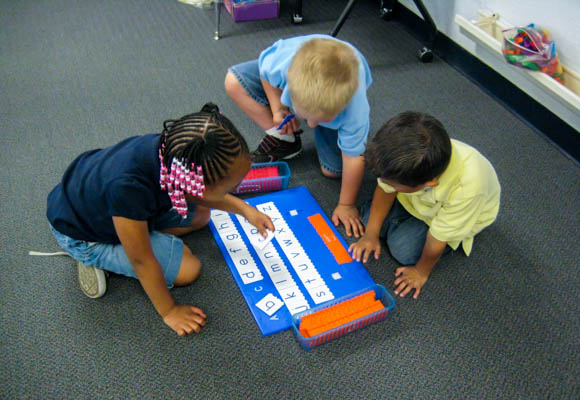 Students work together in learning teams at a literacy center.