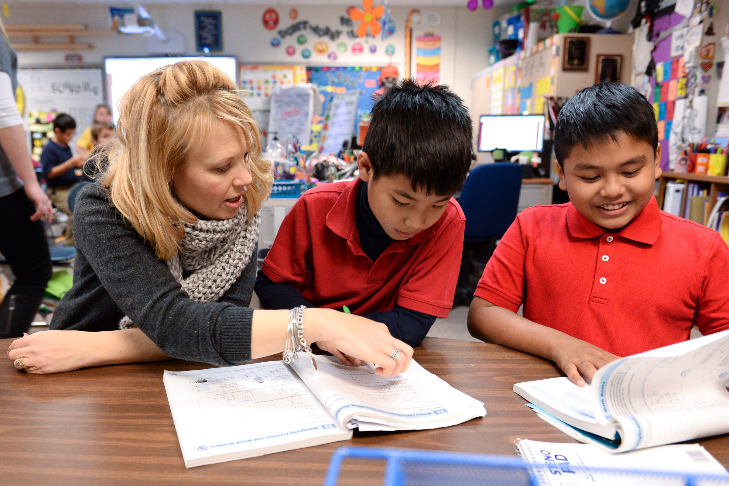 Kelly Wilber helps students with a lesson.