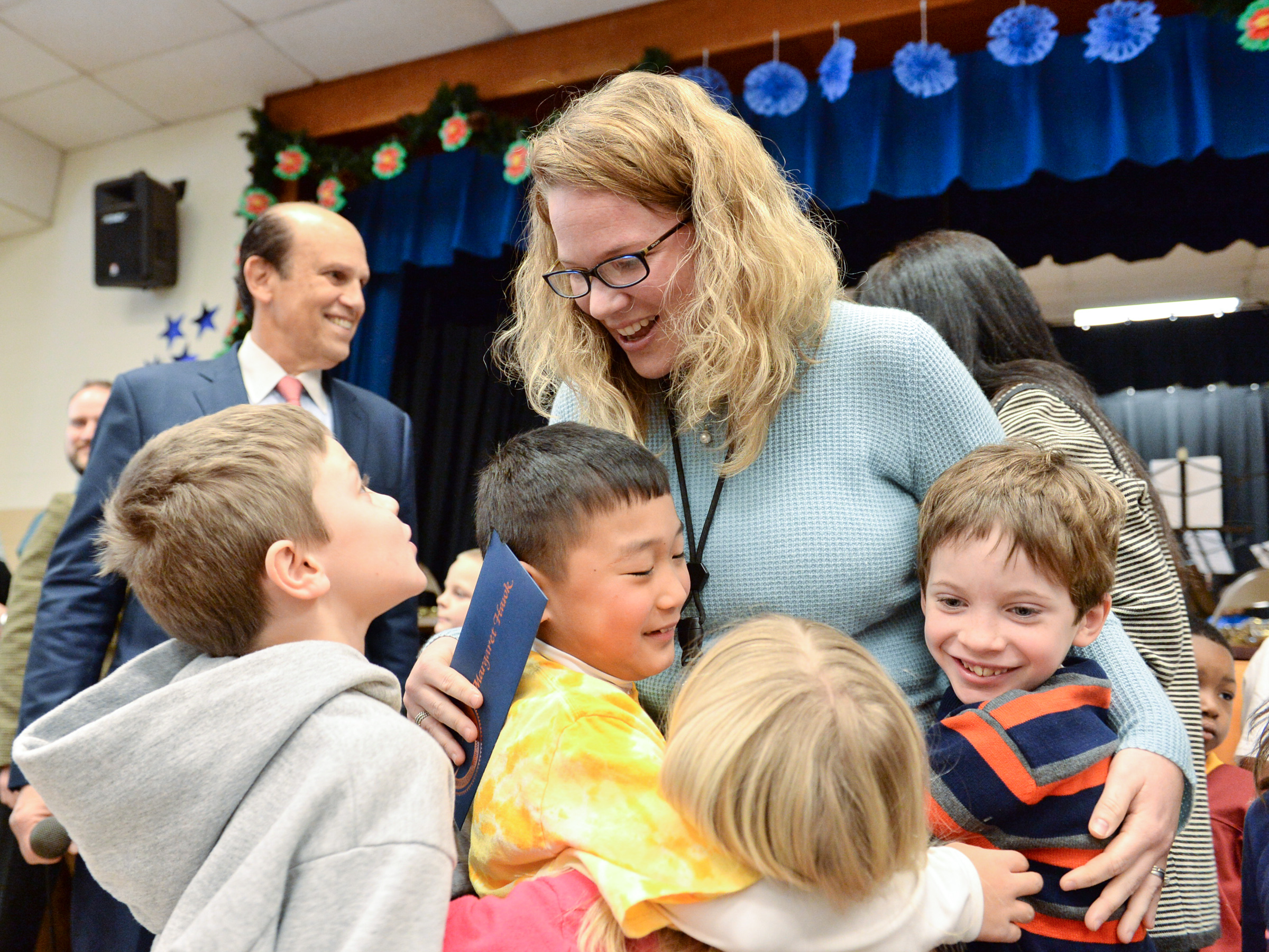 Maggie Hawk hugs students.